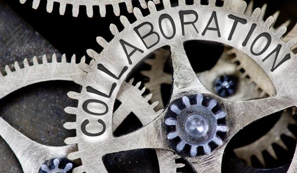 Spinning gears with the word collaboration on them